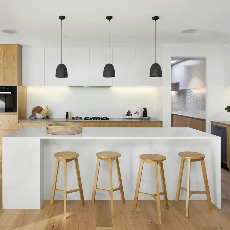 Cocina con isla de madera y taburetes